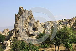 Pigeon lofts carved into the fairy chimneys against a pale blue sky- Cappadocia photo